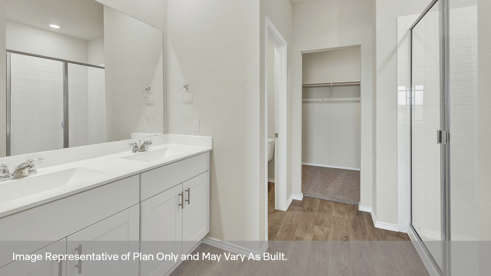 Main bathroom with double sink vanity and white cabinet, walk-in shower, and closet entry.