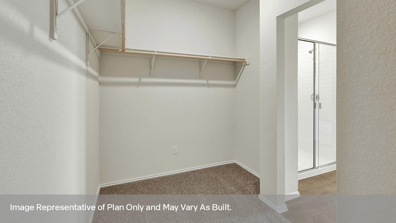 Walk-in closet with wooden shelving and carpeting.