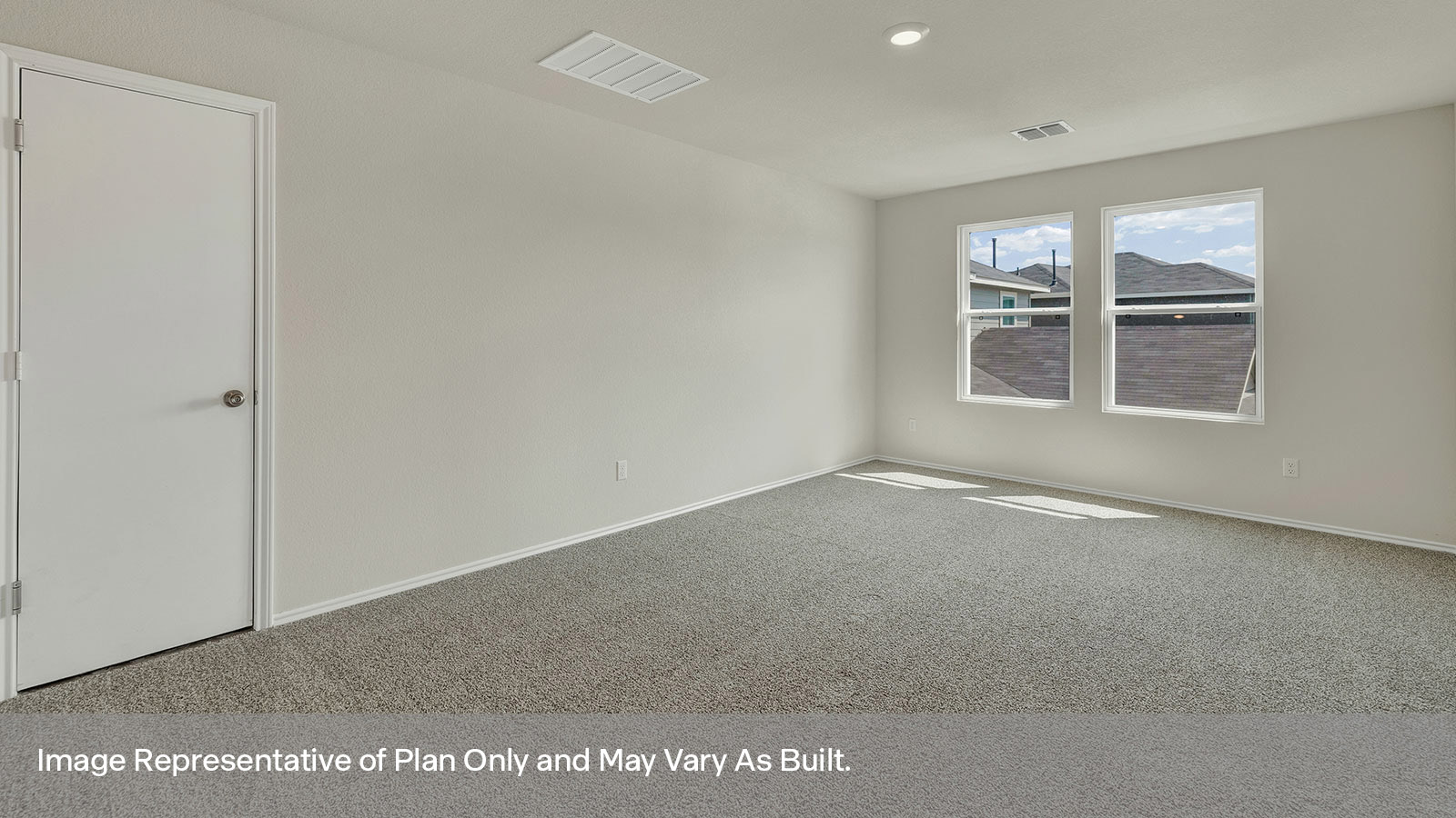 Loft with carpeting and two windows.