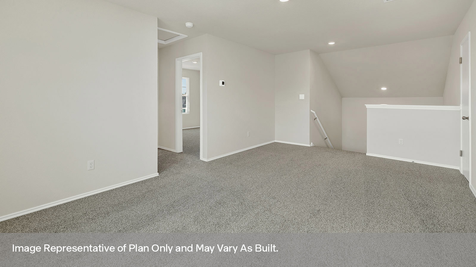 Loft with carpeting and two windows.