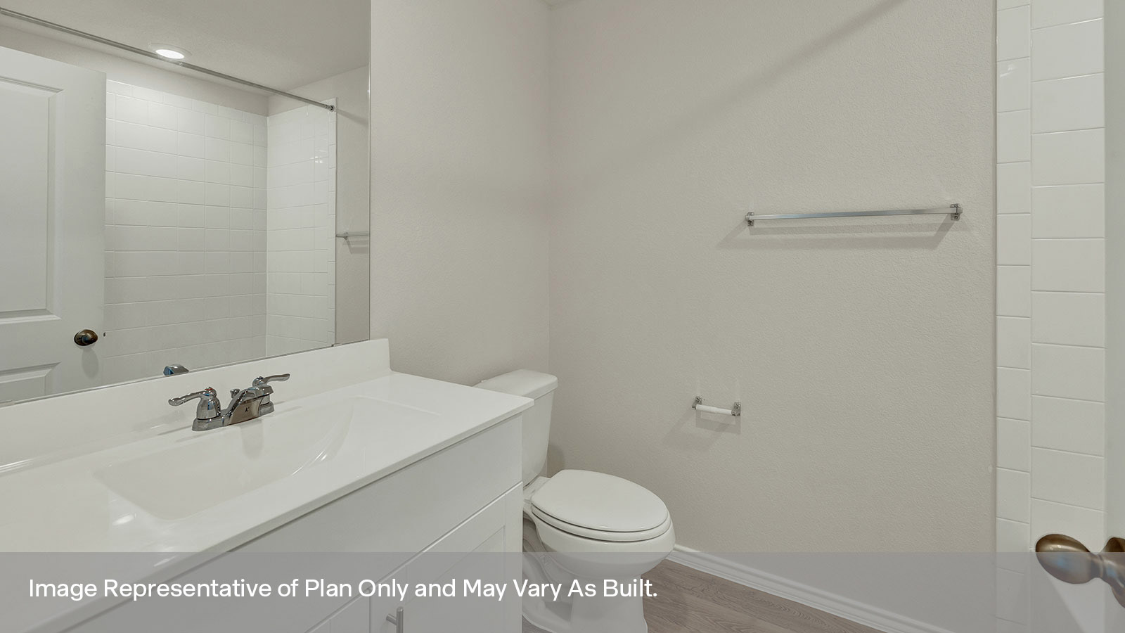 Bathroom with single sink vanity and toilet.