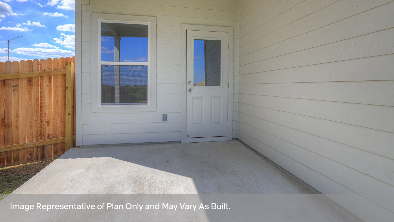 Covered patio with 5 windows, half lite exterior door, and fully sodded backyard.