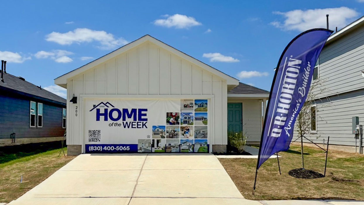 Single-story farmhouse with 2 car garage.b