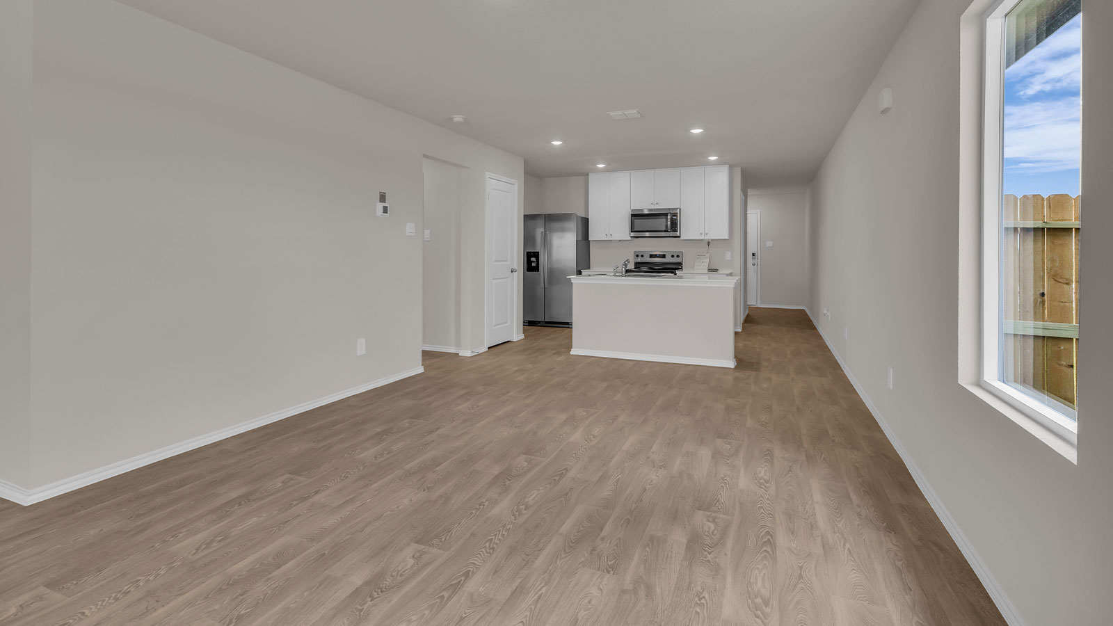 Dining room opening to the kitchen with kitchen island.