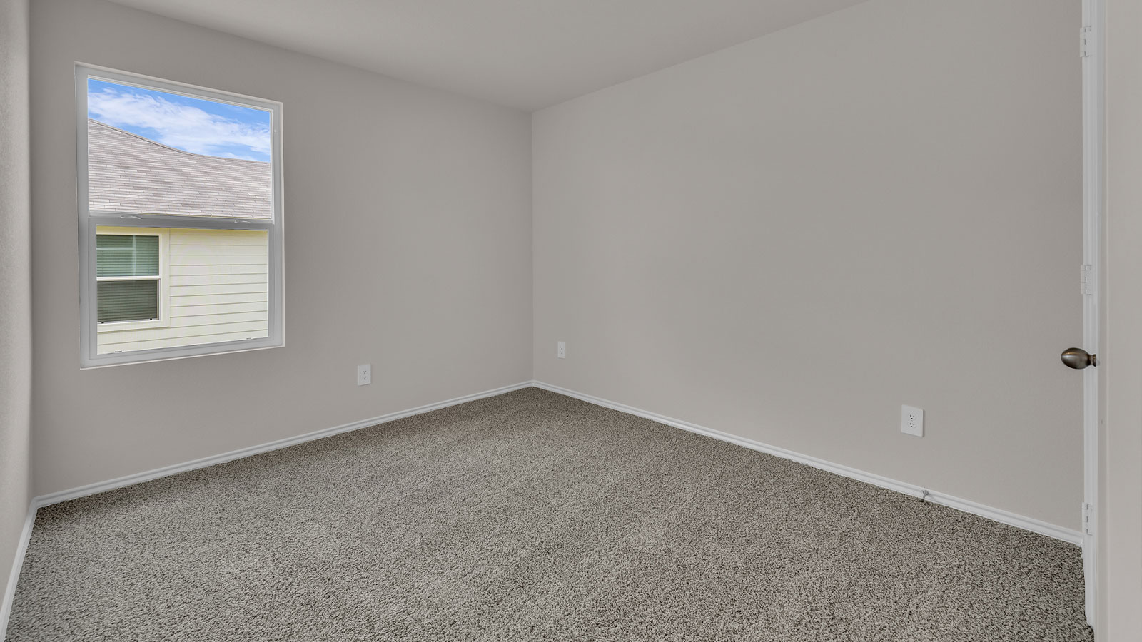 Secondary bedroom with carpeting and one window.