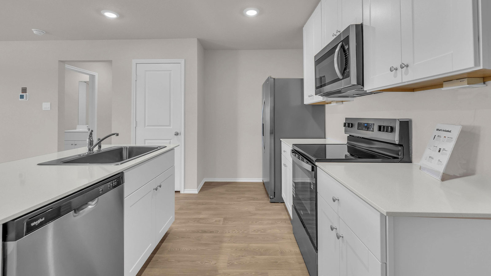 Kitchen with kitchen island and white cabinets.