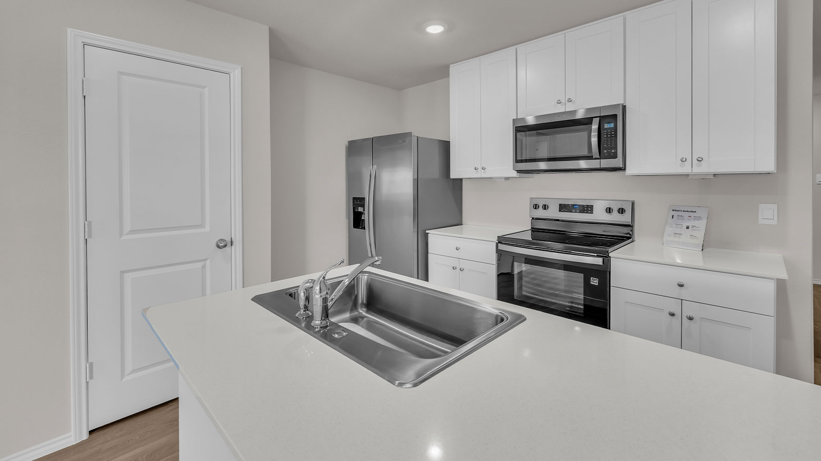 Kitchen with kitchen island and white cabinets.