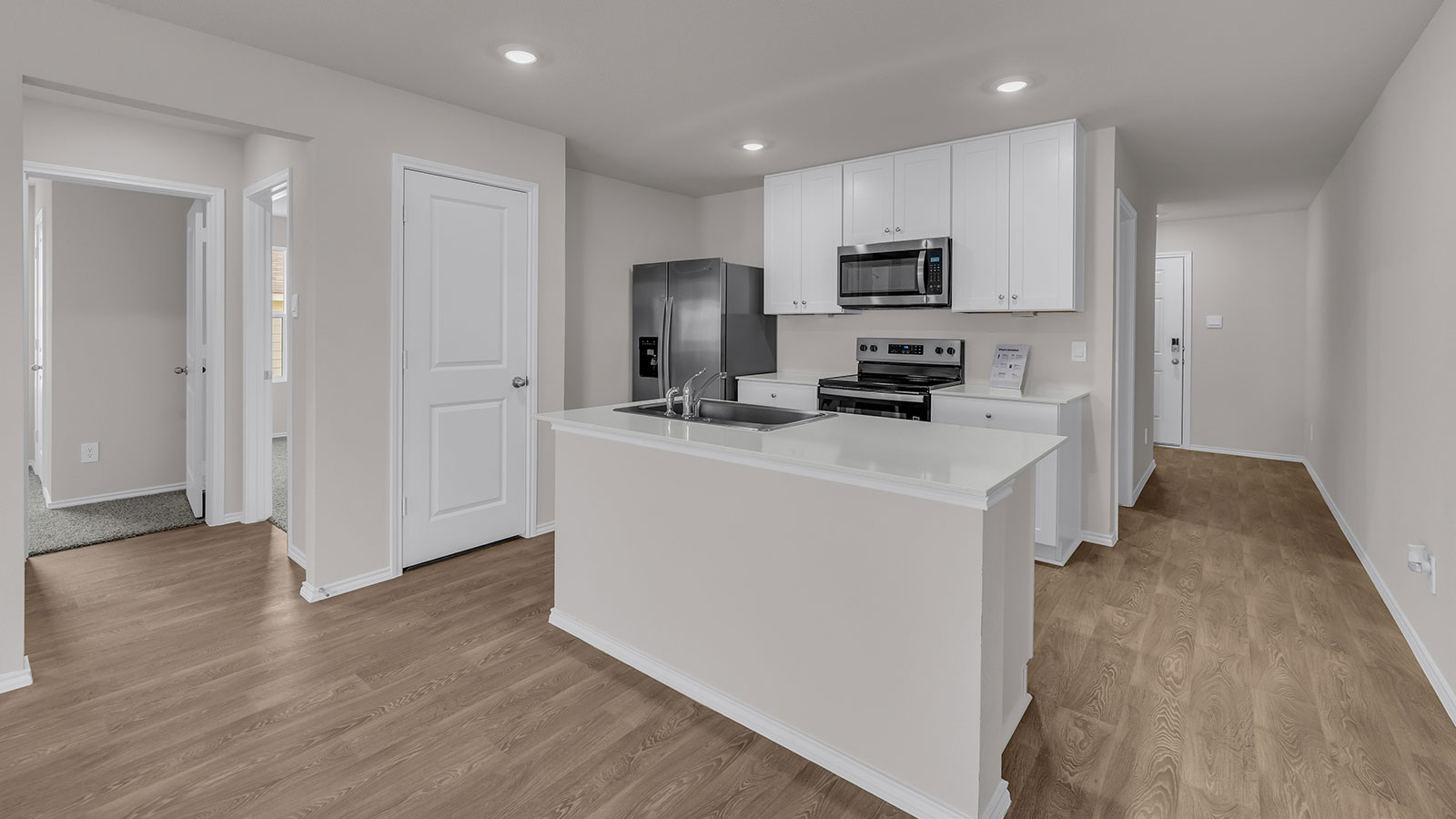 Kitchen with kitchen island and entry hallway.