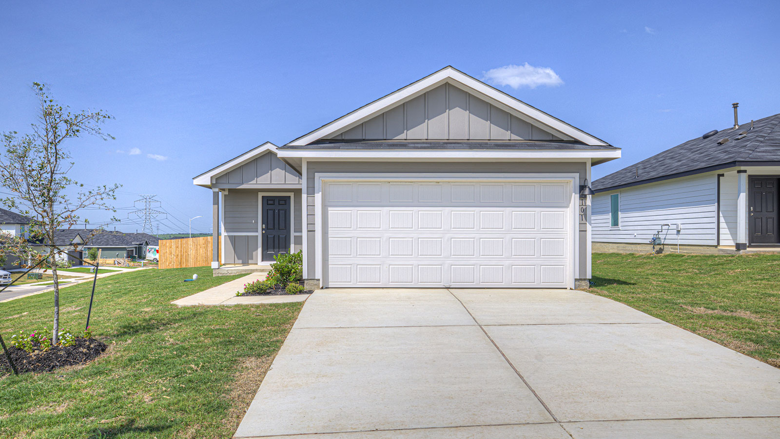 Single-story farmhouse with 2 car garage.