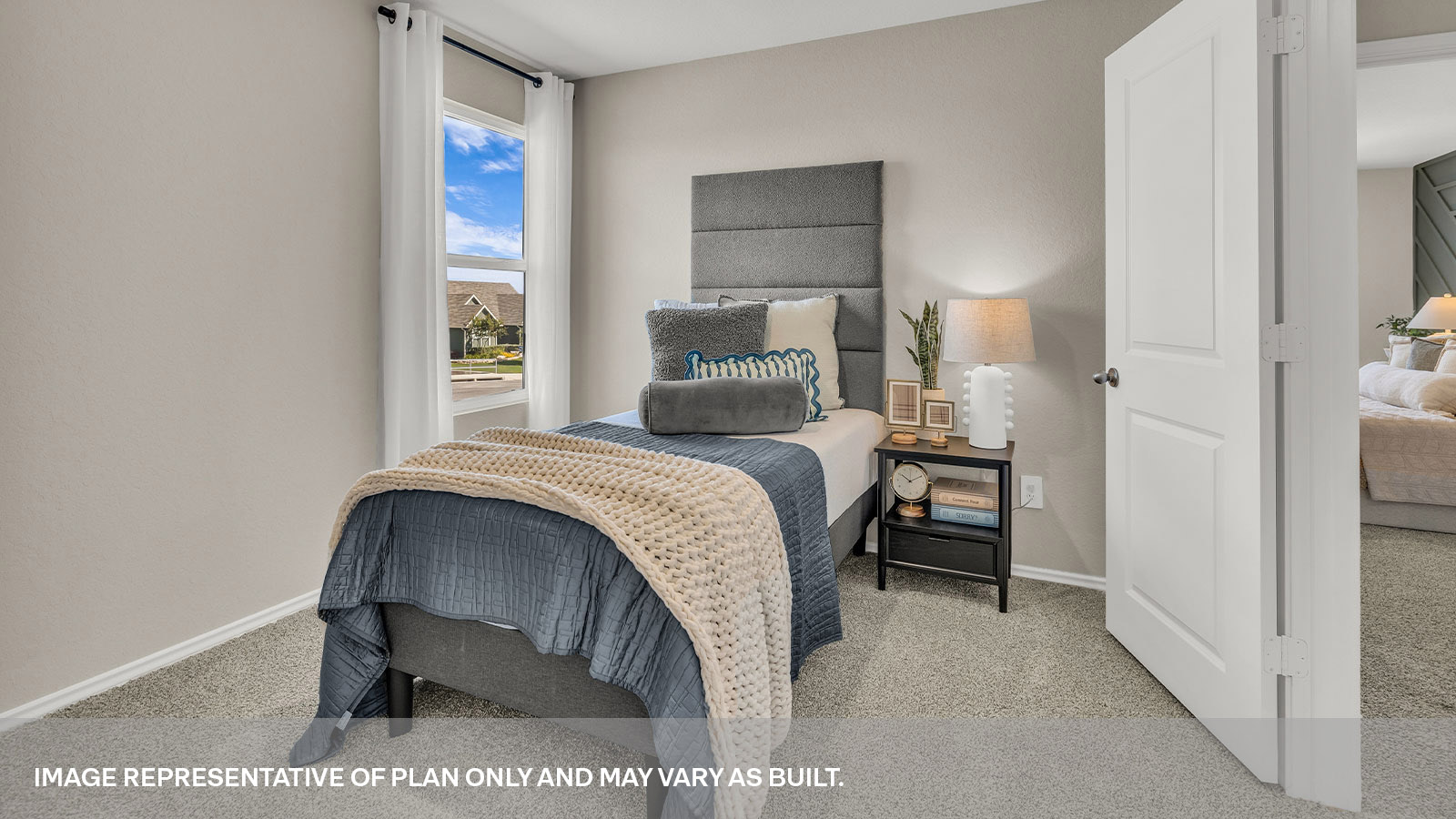 Secondary bedroom with carpeting and one window.