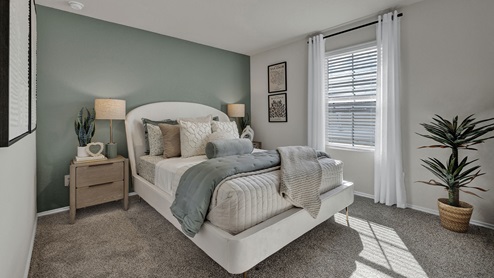 Front bedroom with carpeting and one window.