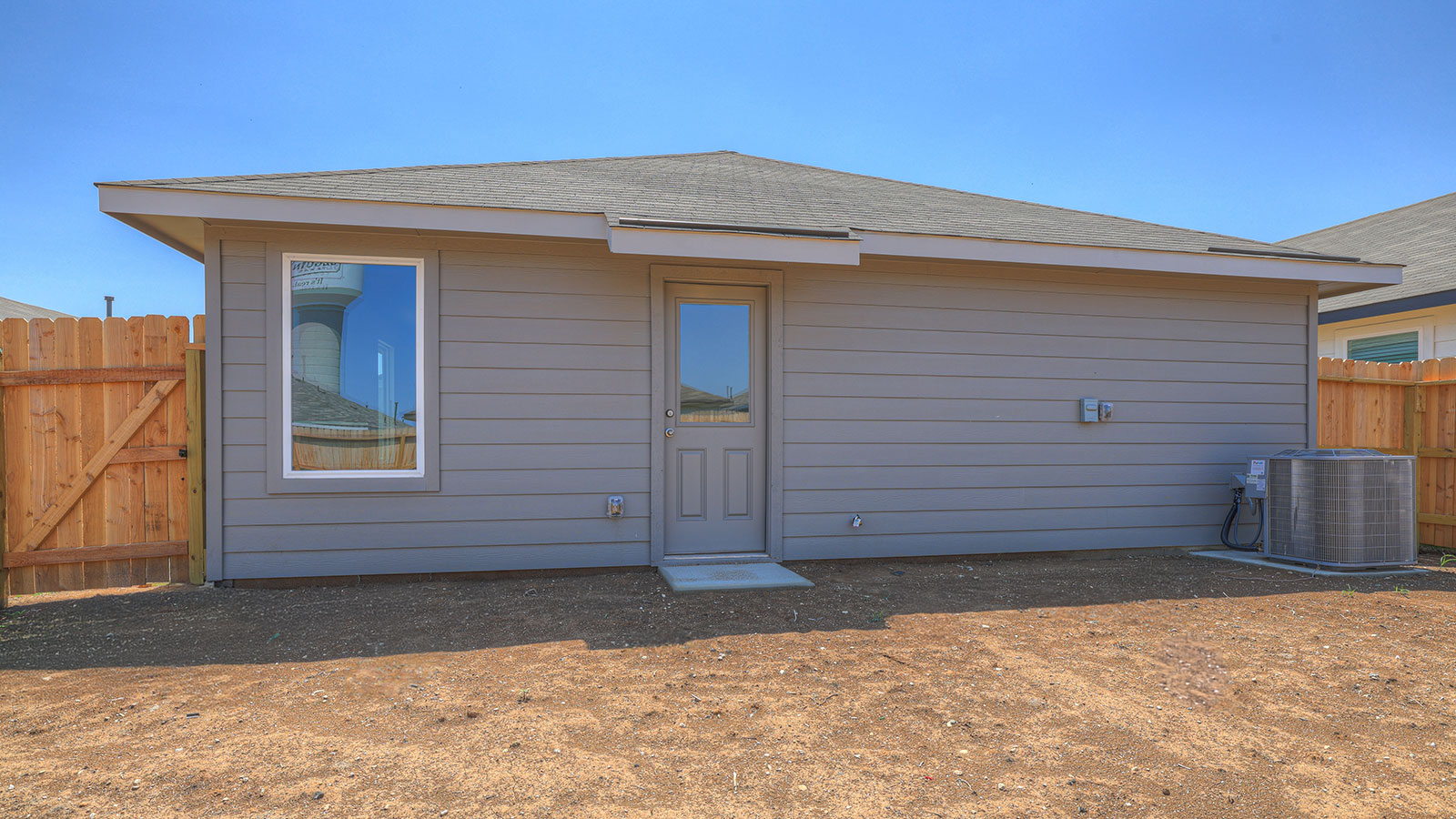Backyard with sod and privacy fence.