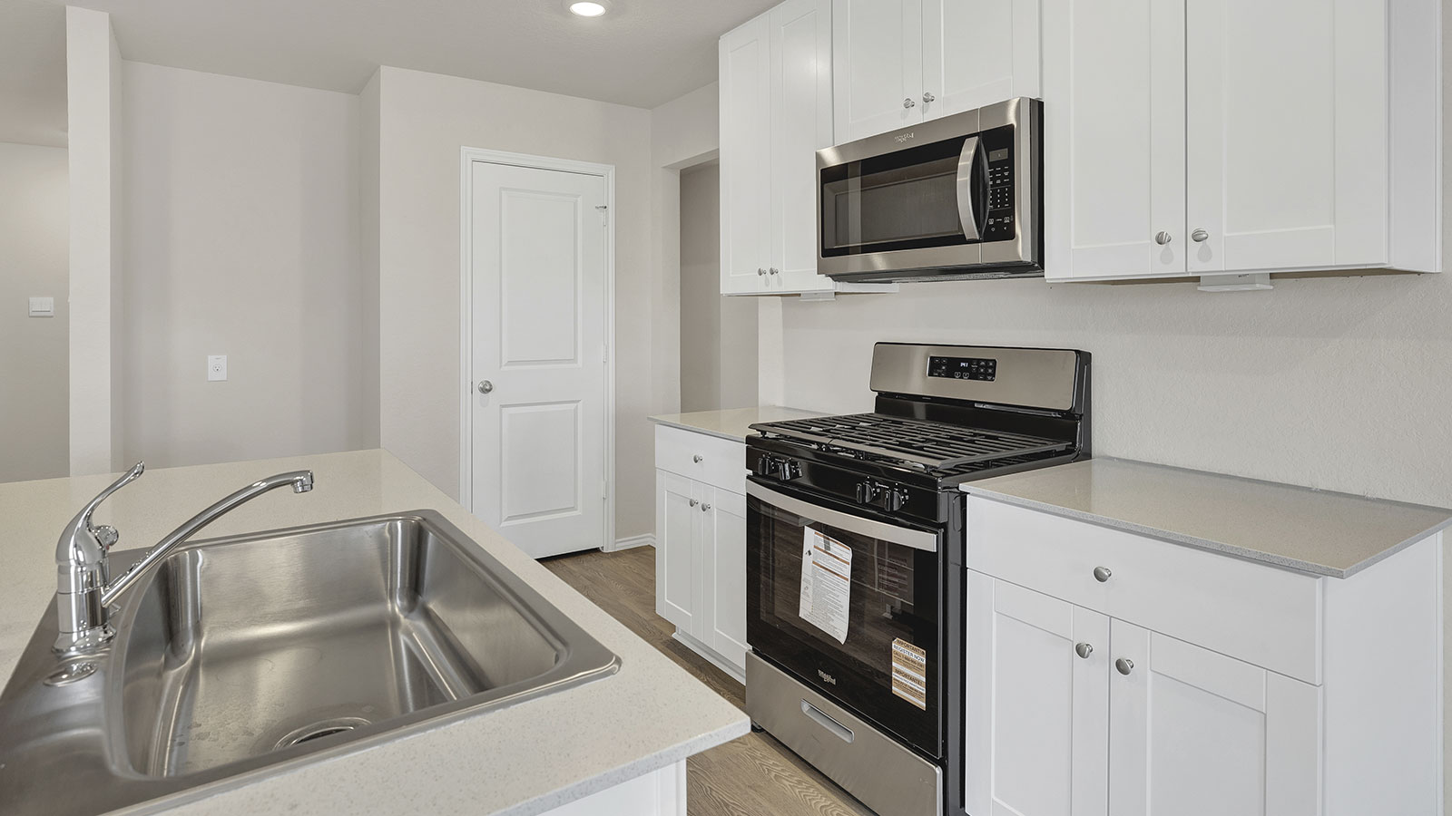 Kitchen with kitchen island and quartz countertops.