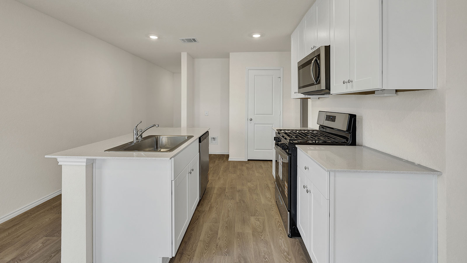 Kitchen with kitchen island overlooking the dining room and living room.