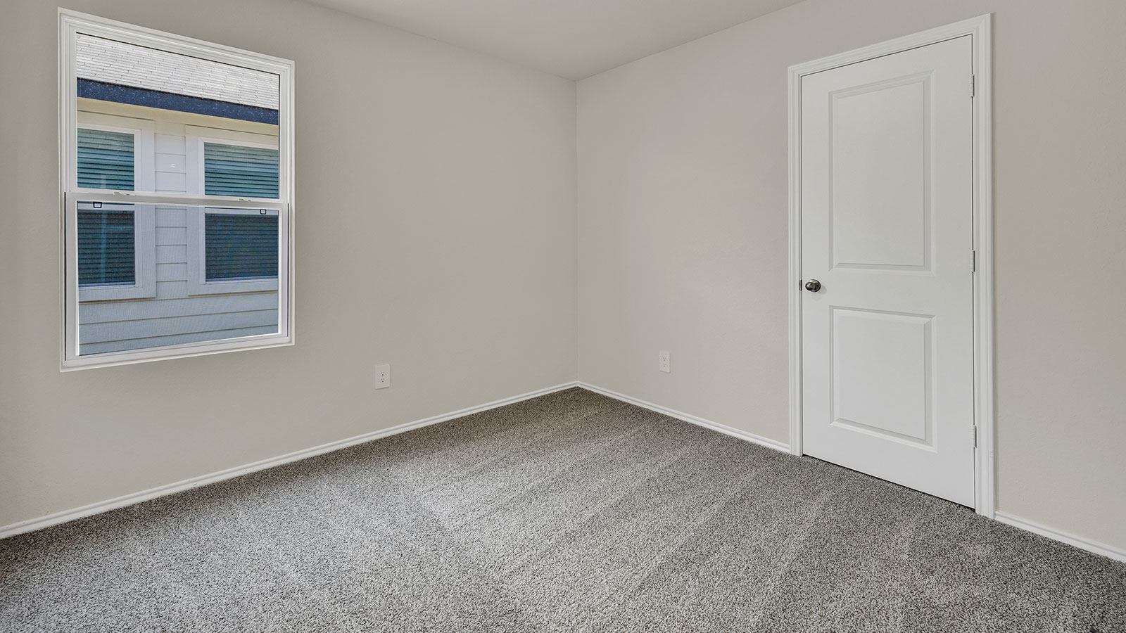 Hall bedroom with carpeting and one window.