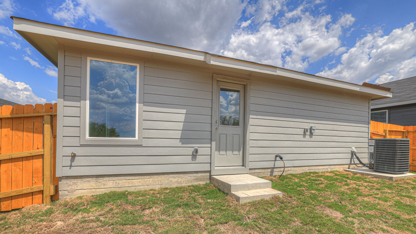 Backyard with sod and privacy fence.