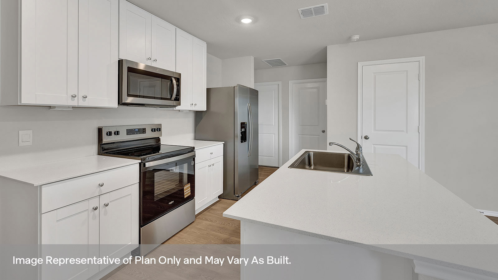 Kitchen with kitchen island and entry hallway.