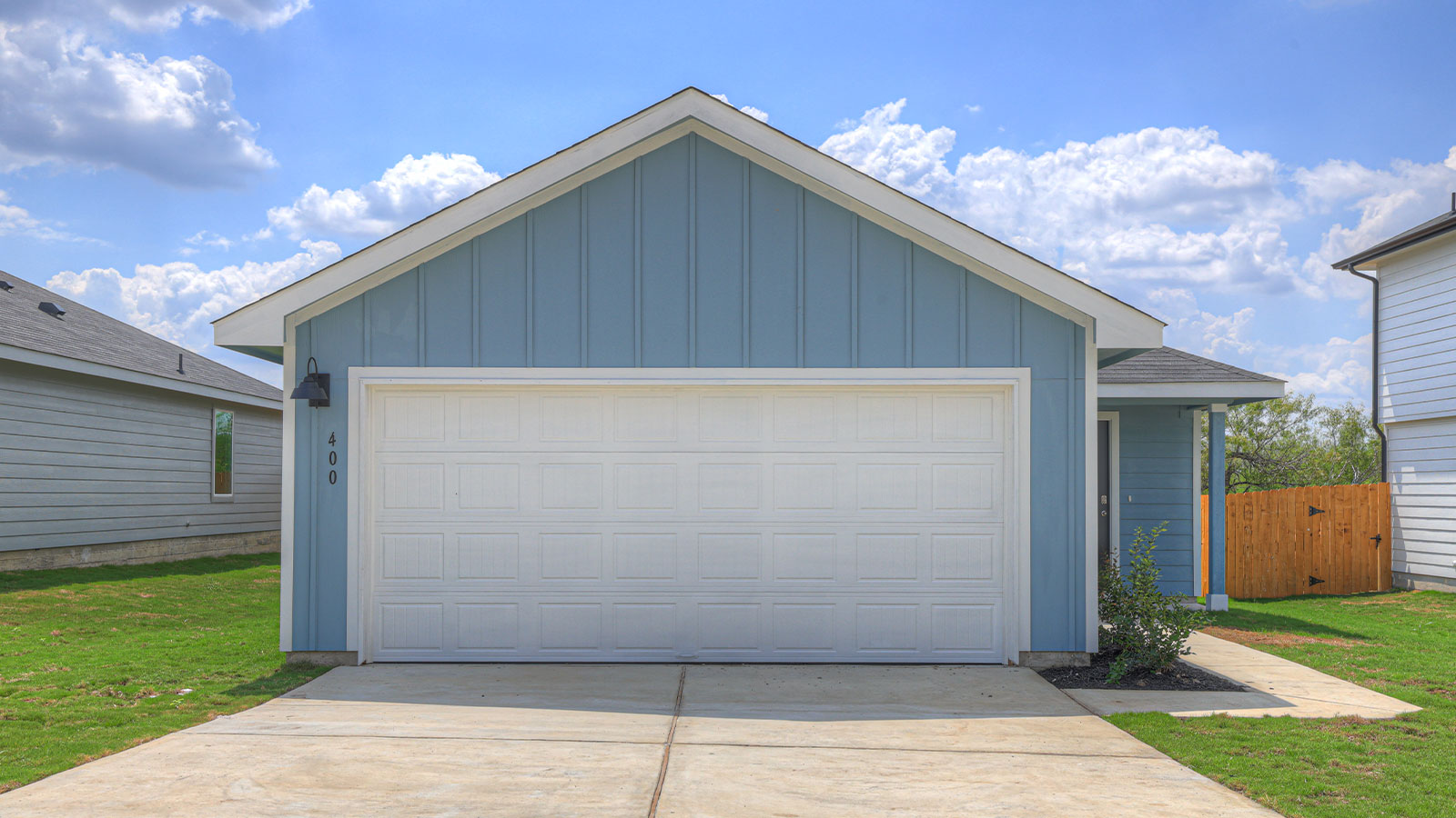 Single-story farmhouse with 2 car garage.