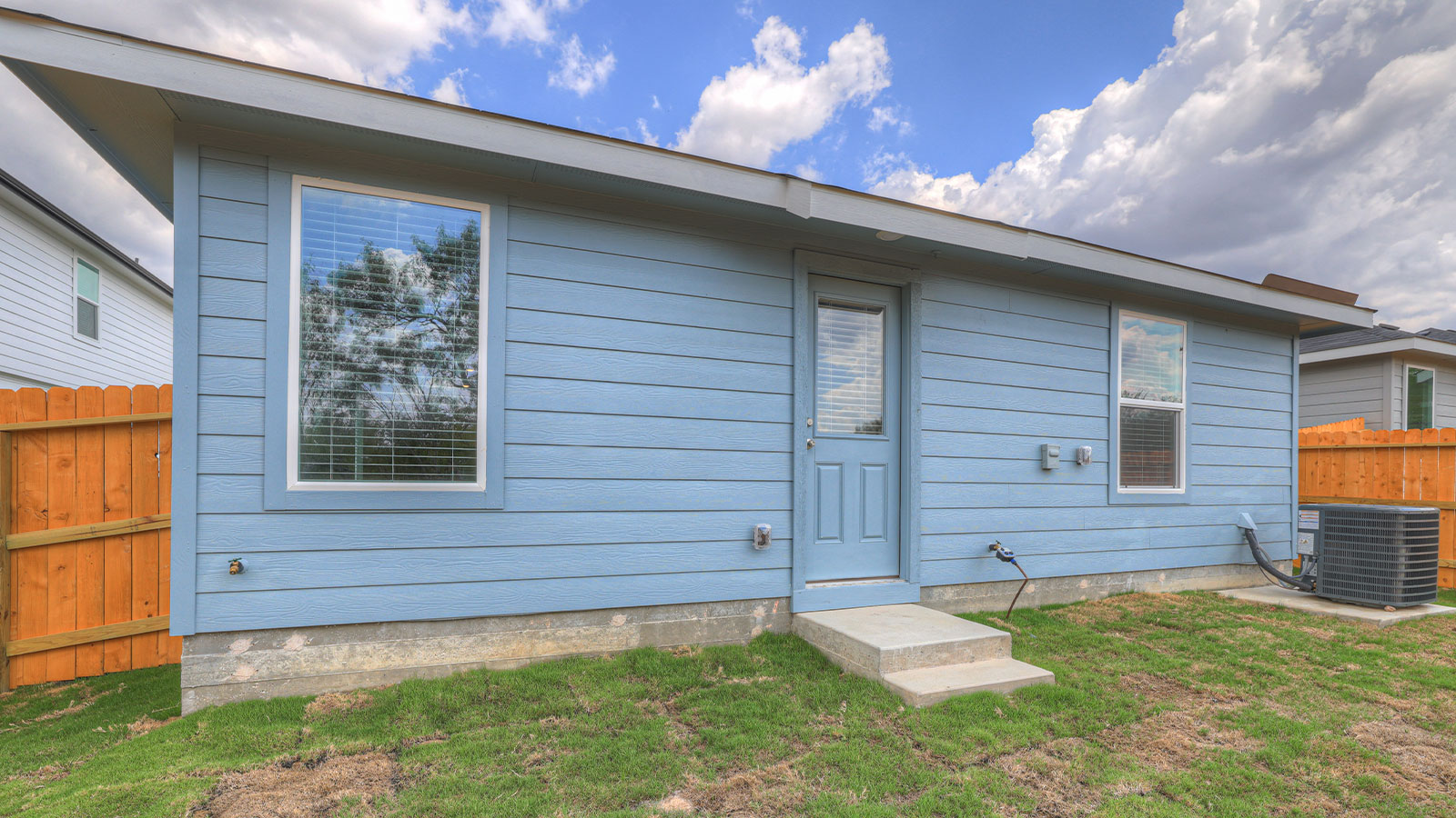 Backyard with sod and privacy fence.