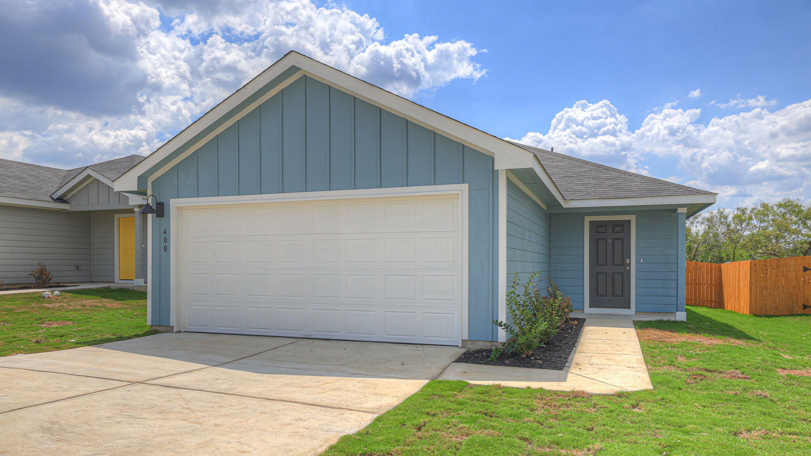 Single-story farmhouse with 2 car garage.