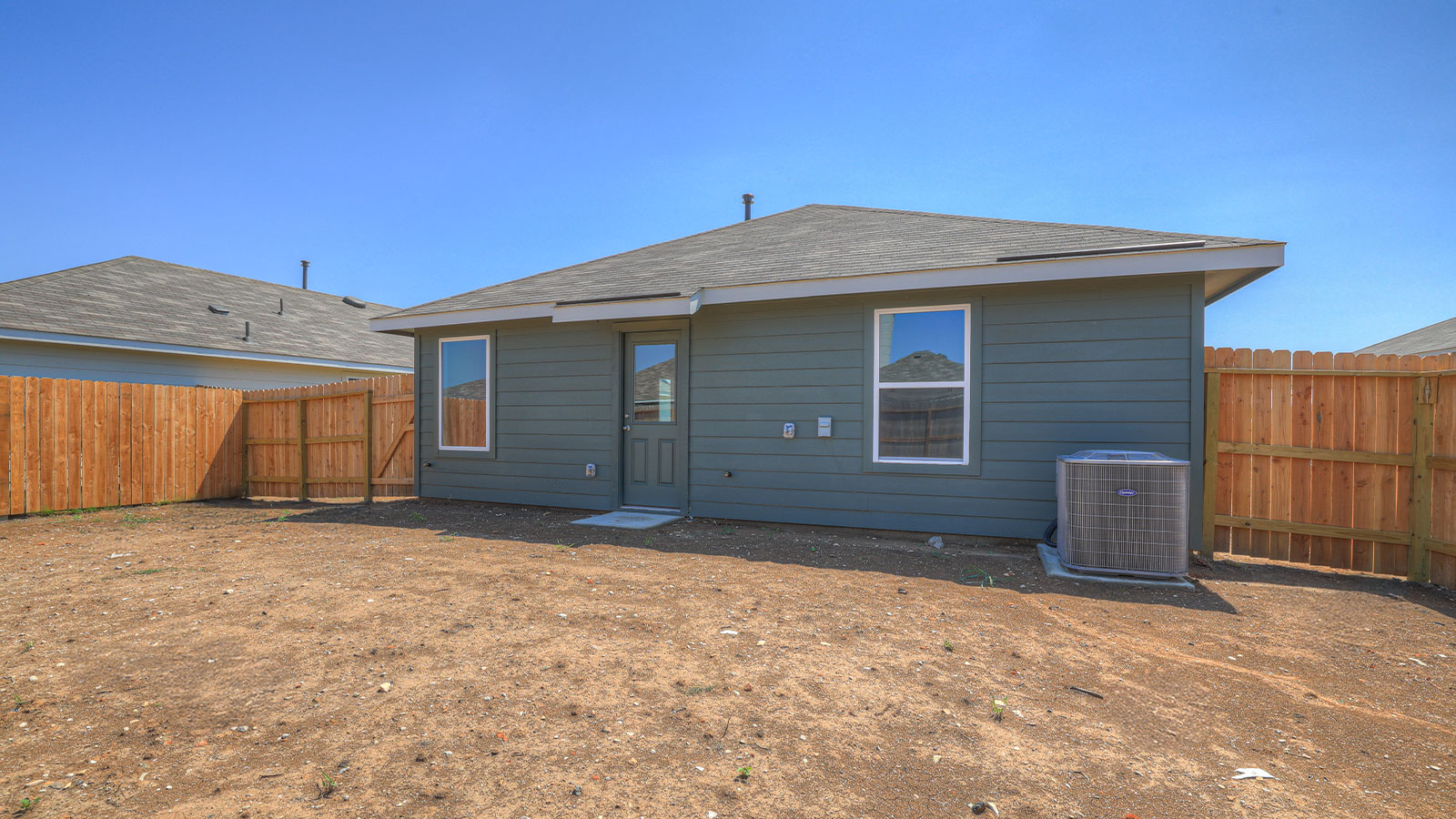 Backyard with sod and privacy fence.