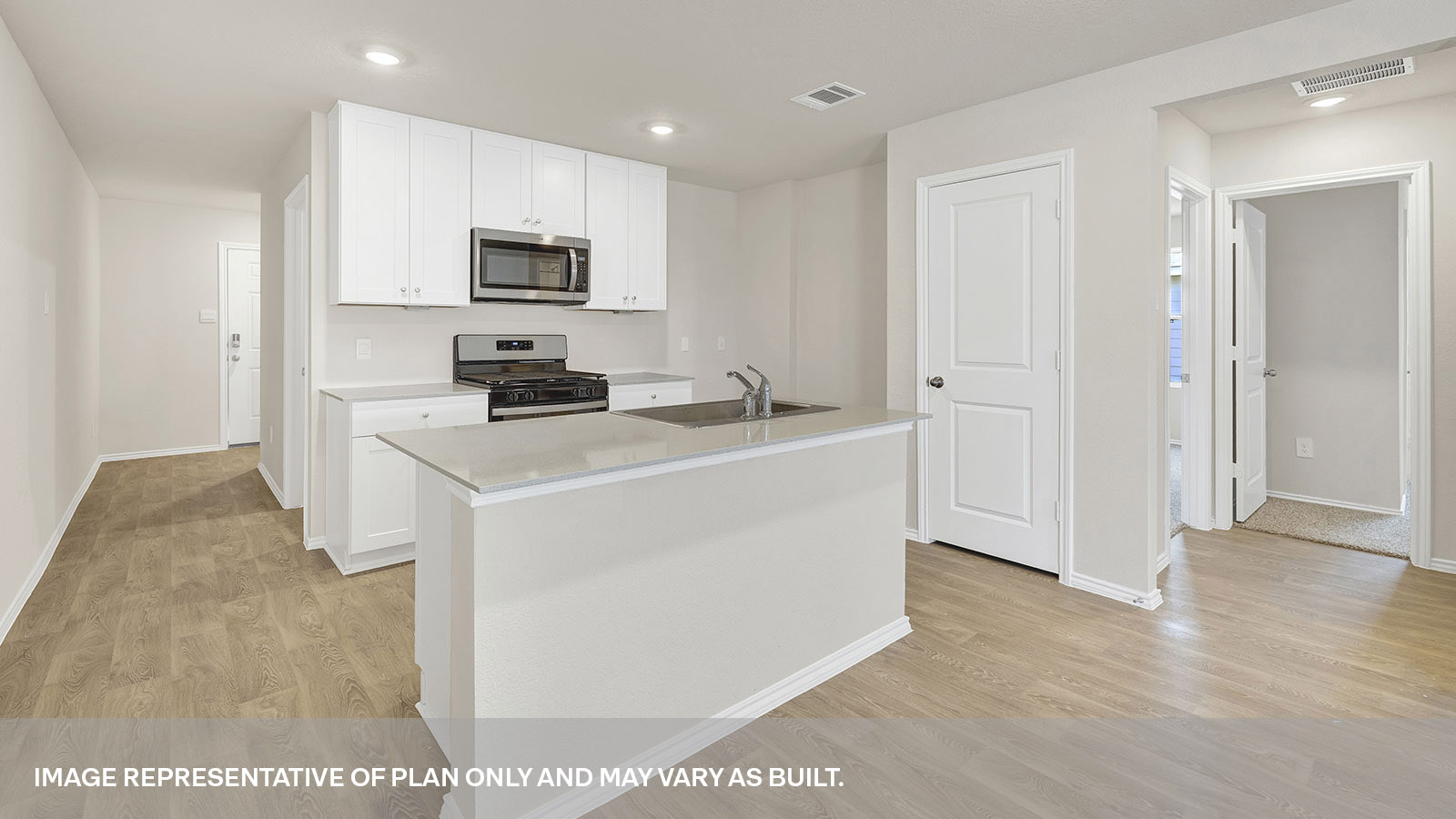 Kitchen with kitchen island and entry hallway.