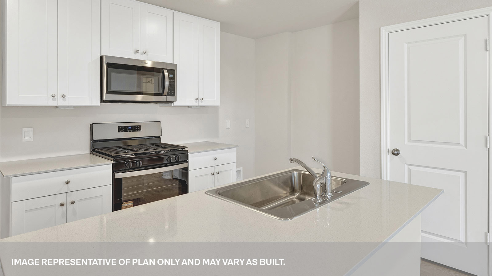 Kitchen with kitchen island and white cabinets.