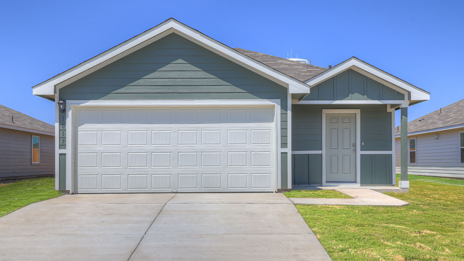 Single-story farmhouse with 2 car garage.