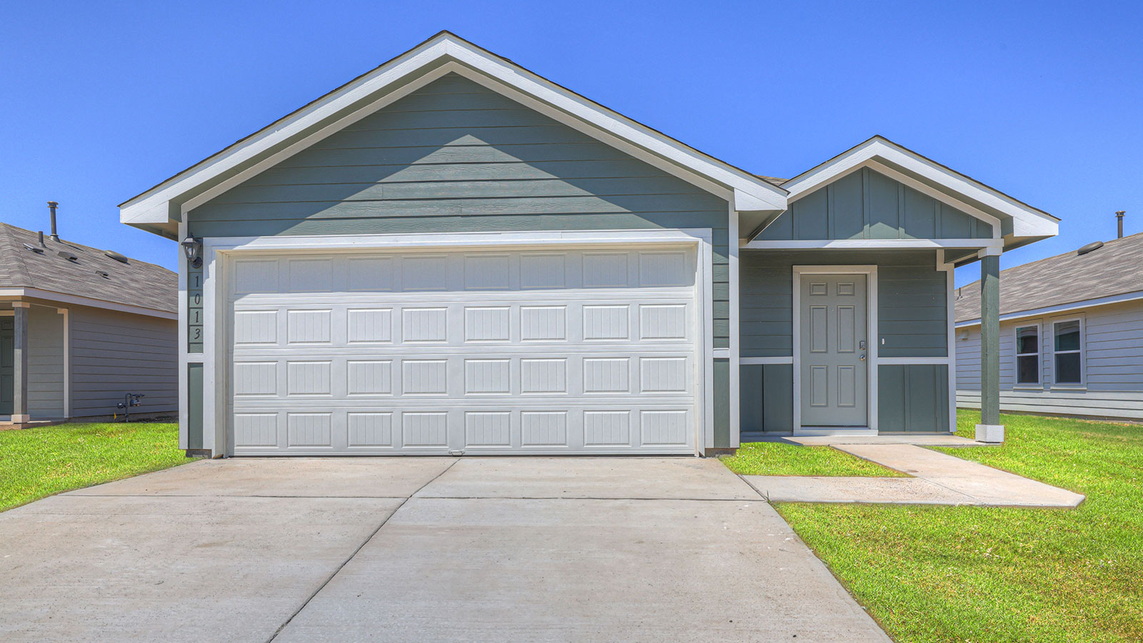 Single-story farmhouse with 2 car garage.