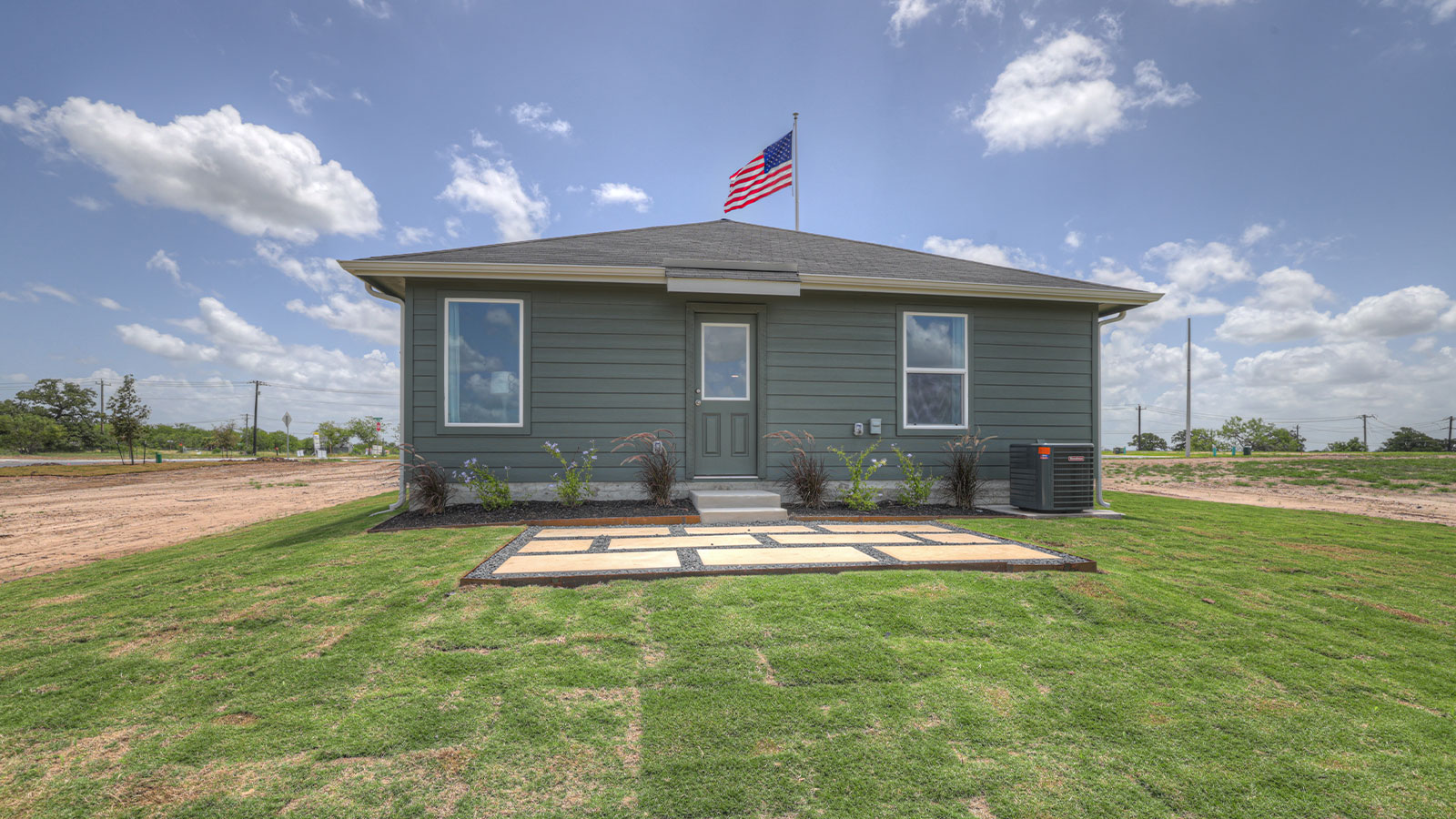 Backyard with 2 windows, and a half lite exterior door.