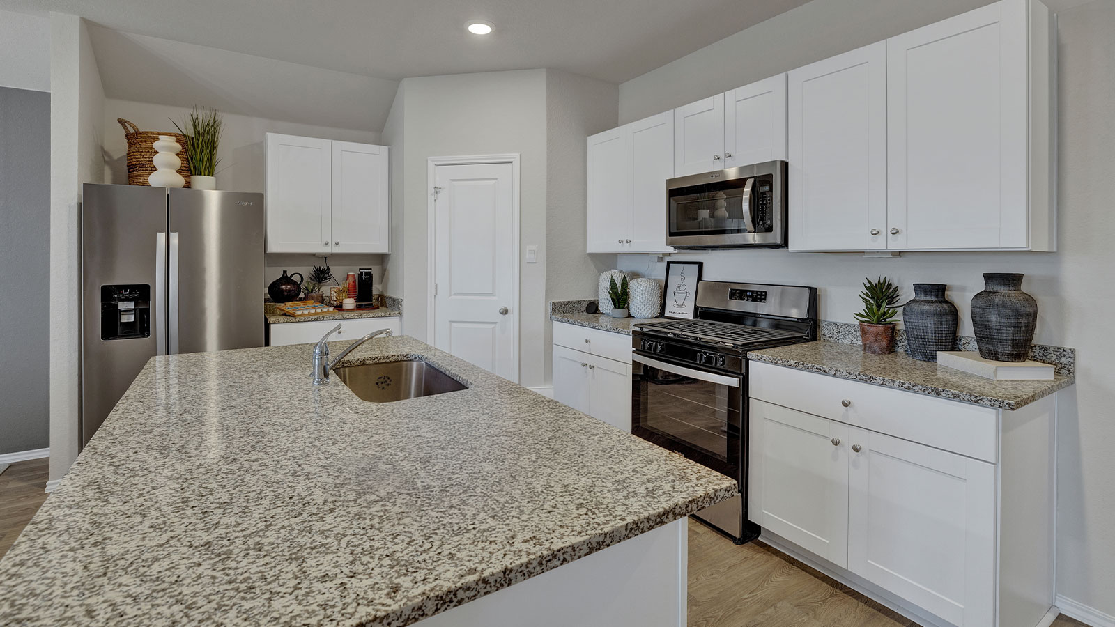 Kitchen with kitchen island and granite countertops.