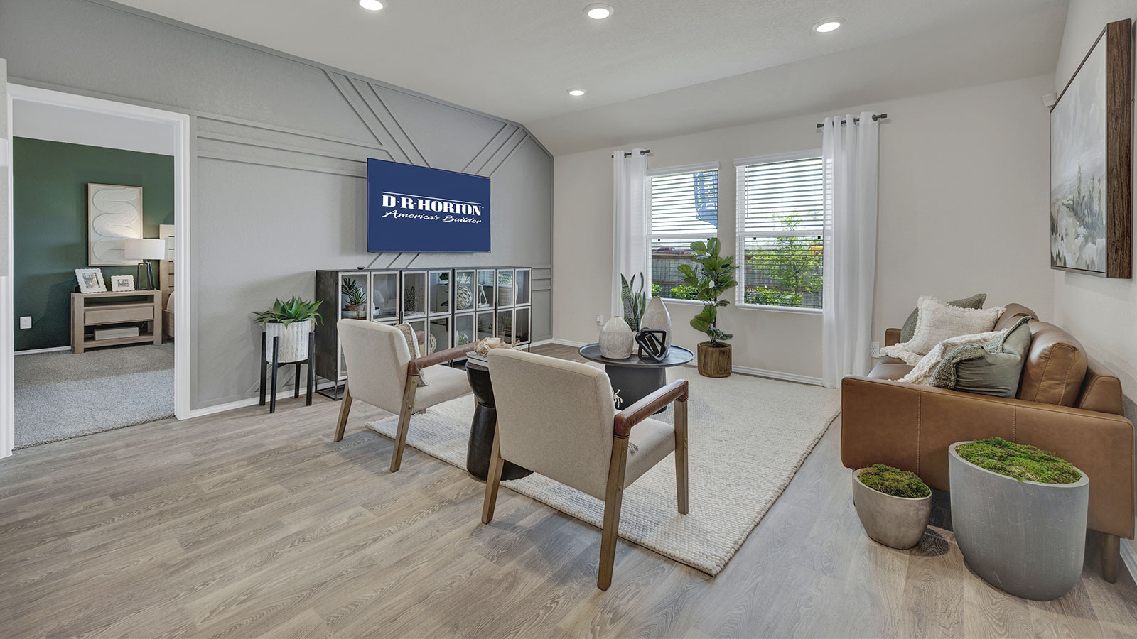 Living room with vinyl flooring and two windows.