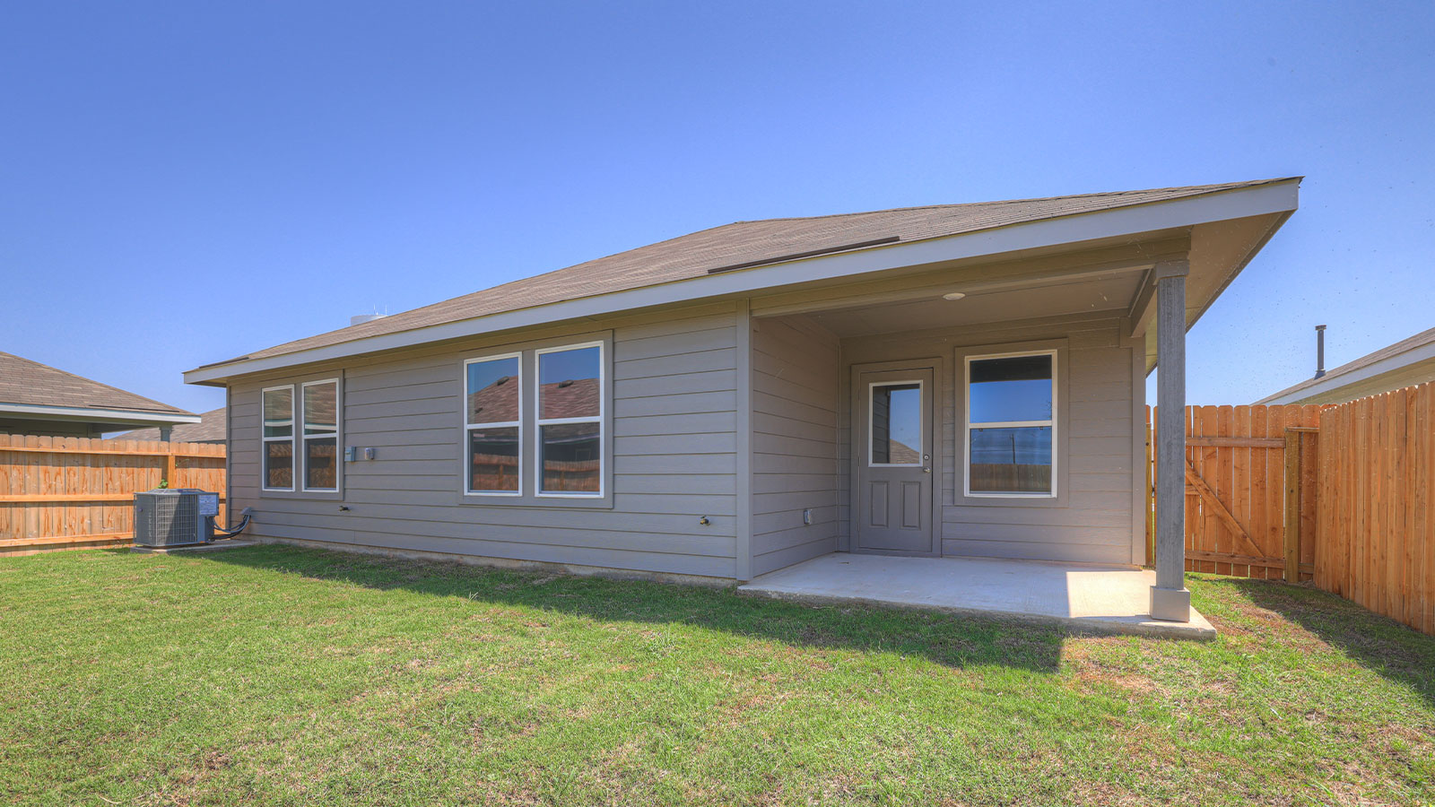 Covered patio with fully sodded backyard.