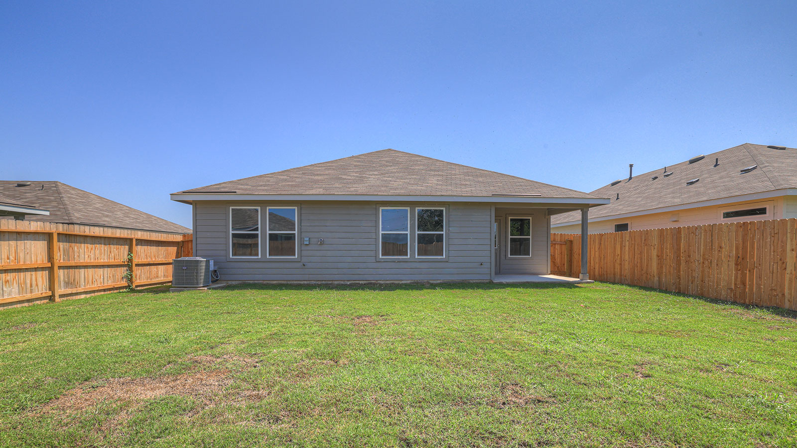 Covered patio with one window and a half lite exterior door.