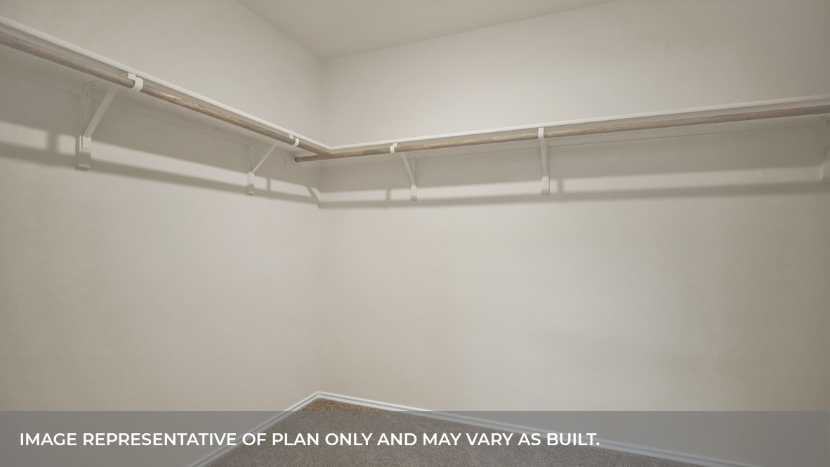 Main bedroom closet with carpeting with wooden shelving.