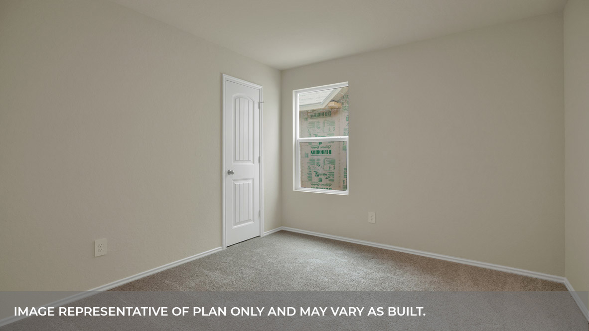Bedroom with carpeting and one window.