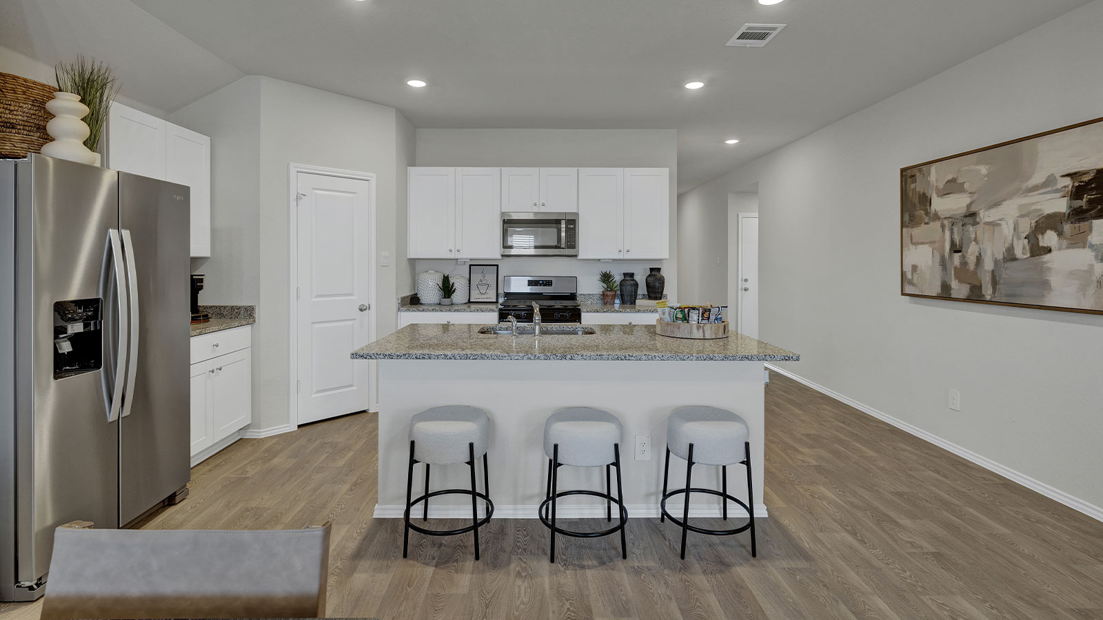 Kitchen with kitchen island and entry hallway.