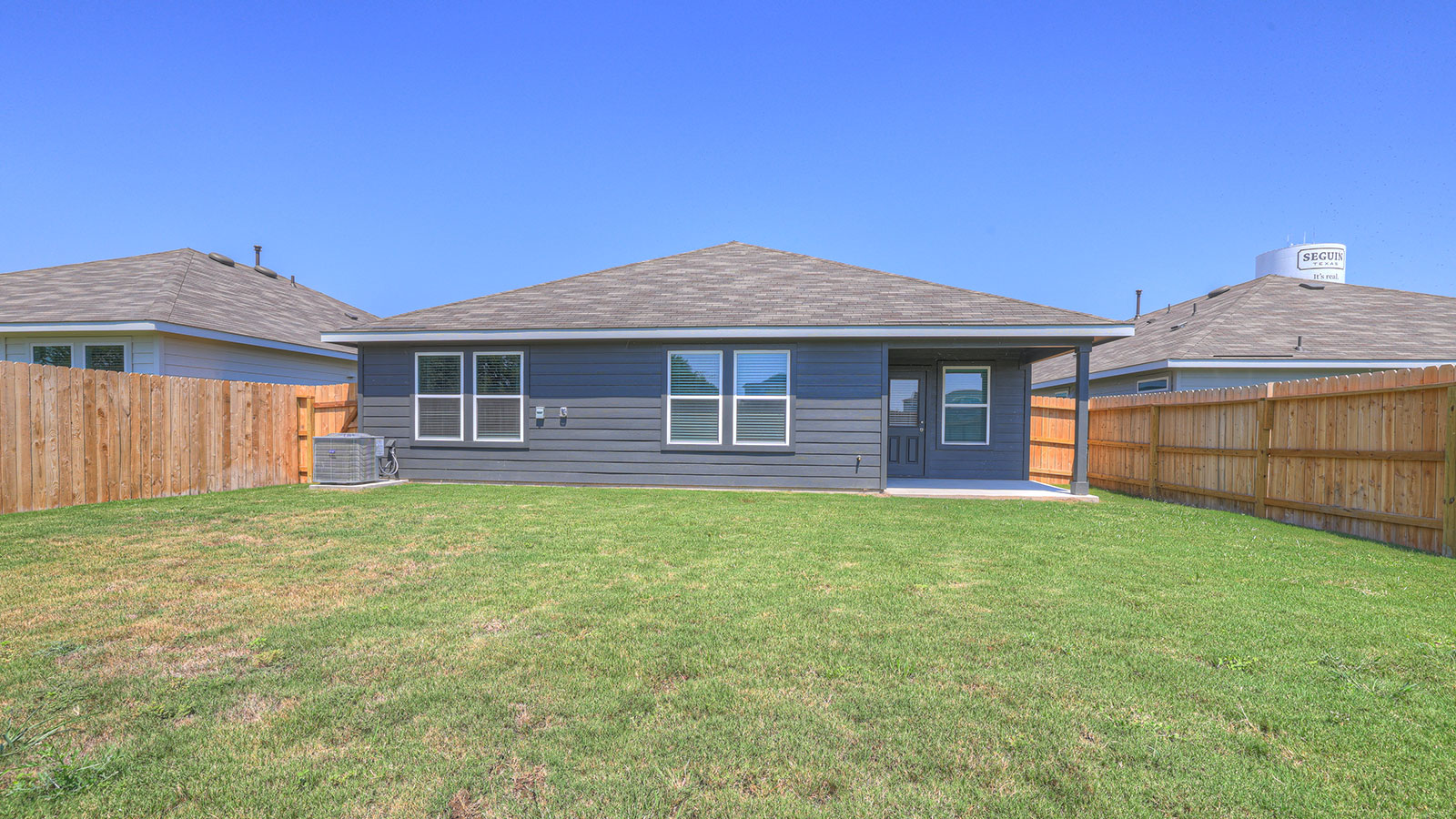 Covered patio with one window and a half lite exterior door.
