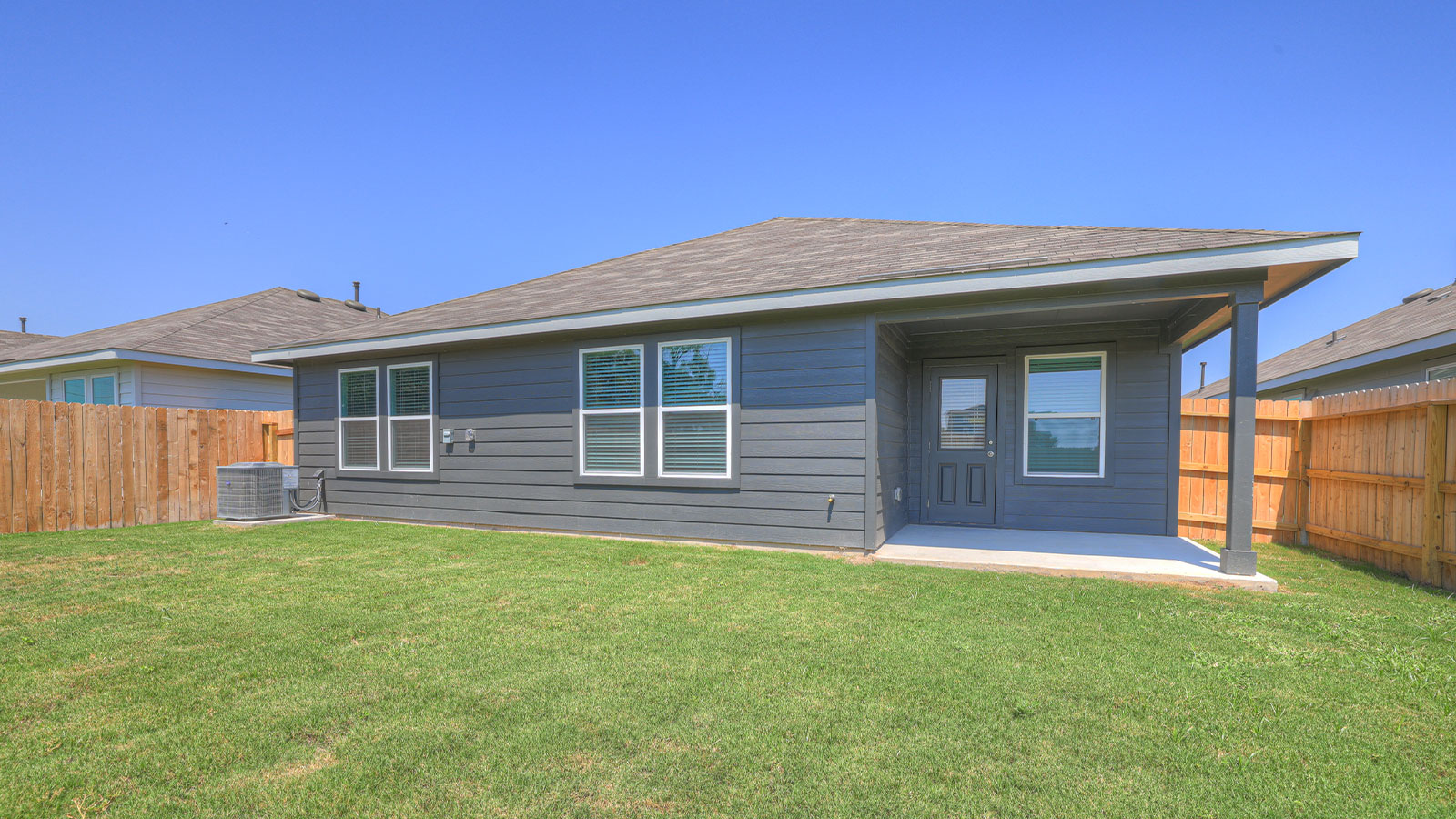 Covered patio with one window and a half lite exterior door.