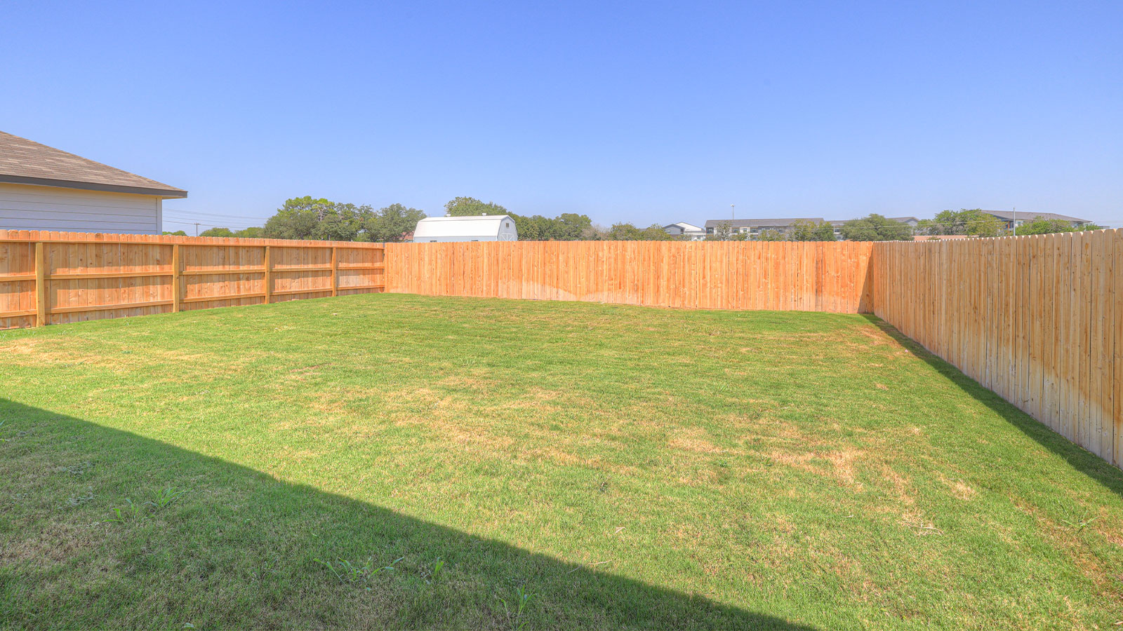 Covered patio with one window and a half lite exterior door.