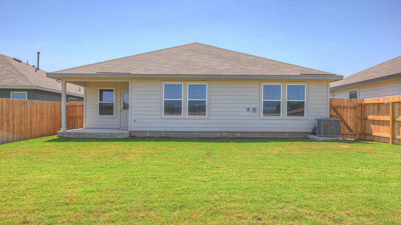 Covered patio with fully sodded backyard.