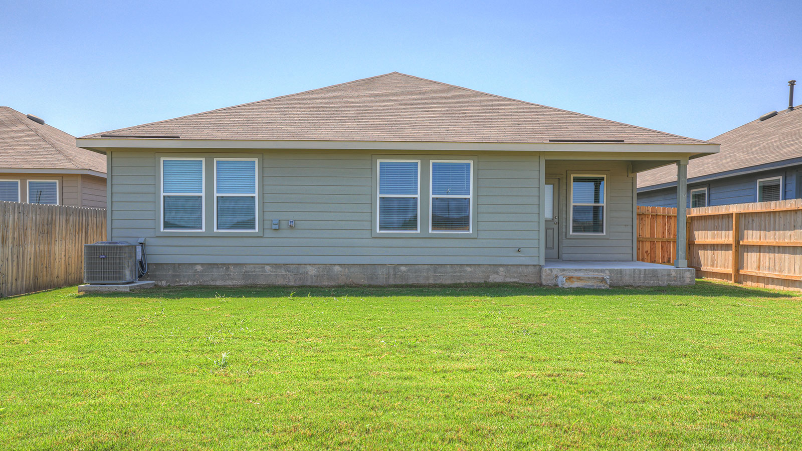 Covered patio with one window and a half lite exterior door.