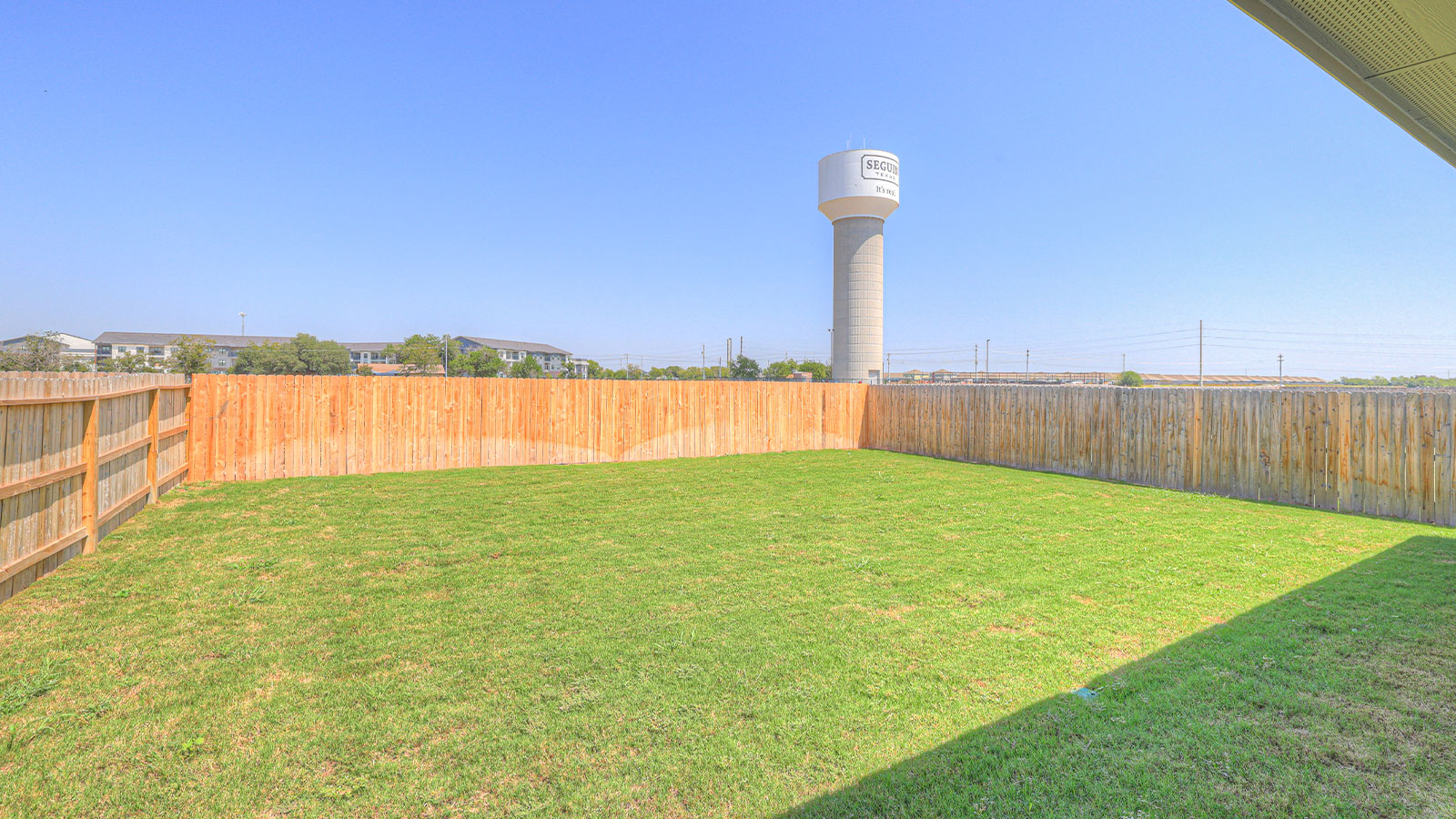 Covered patio with fully sodded backyard.