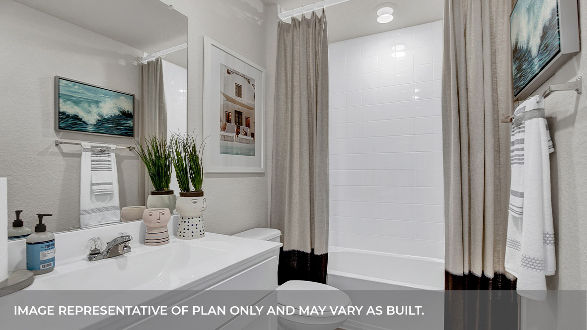 Hall bathroom with single sink vanity, toilet, and tub.