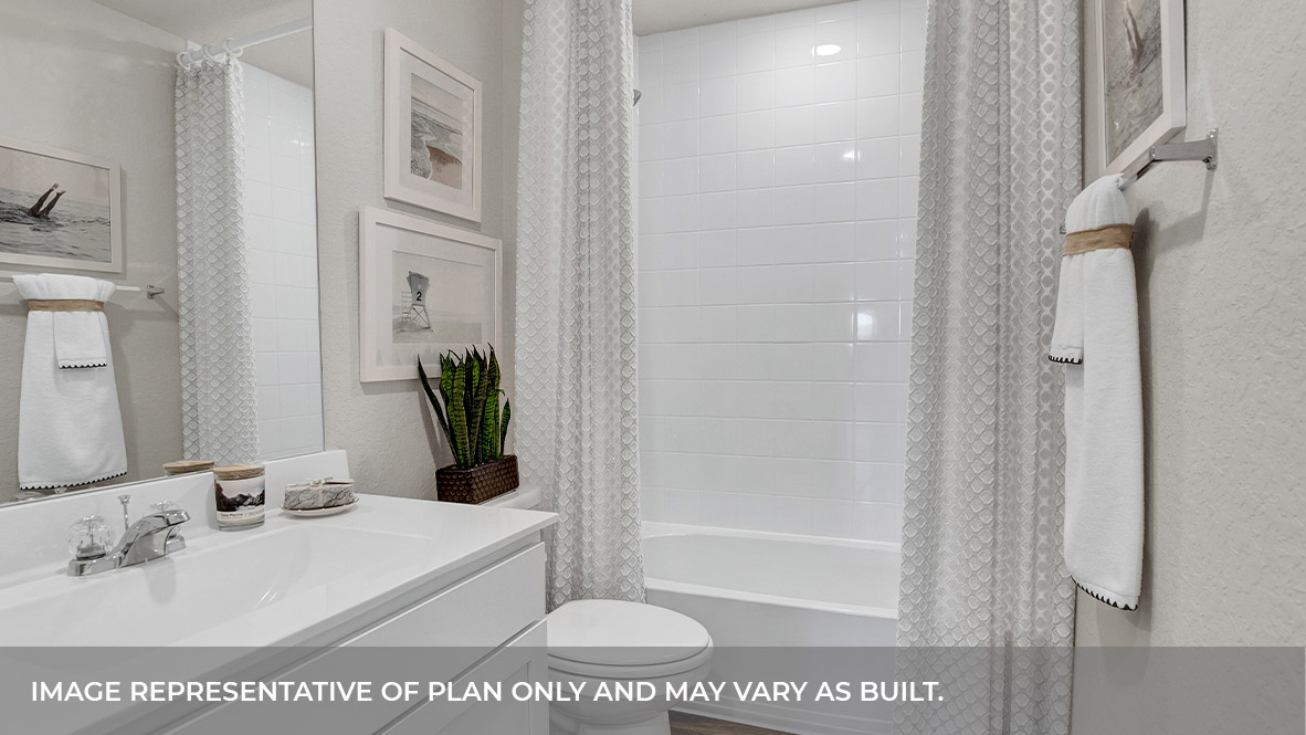 Hall bathroom with single sink vanity, toilet, and tub.