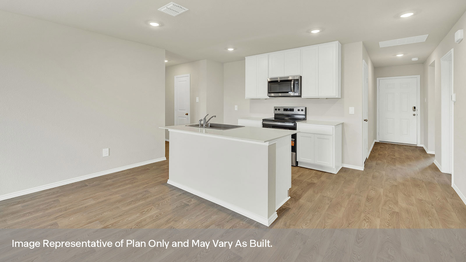 Entry hallway leading to the kitchen with kitchen island.