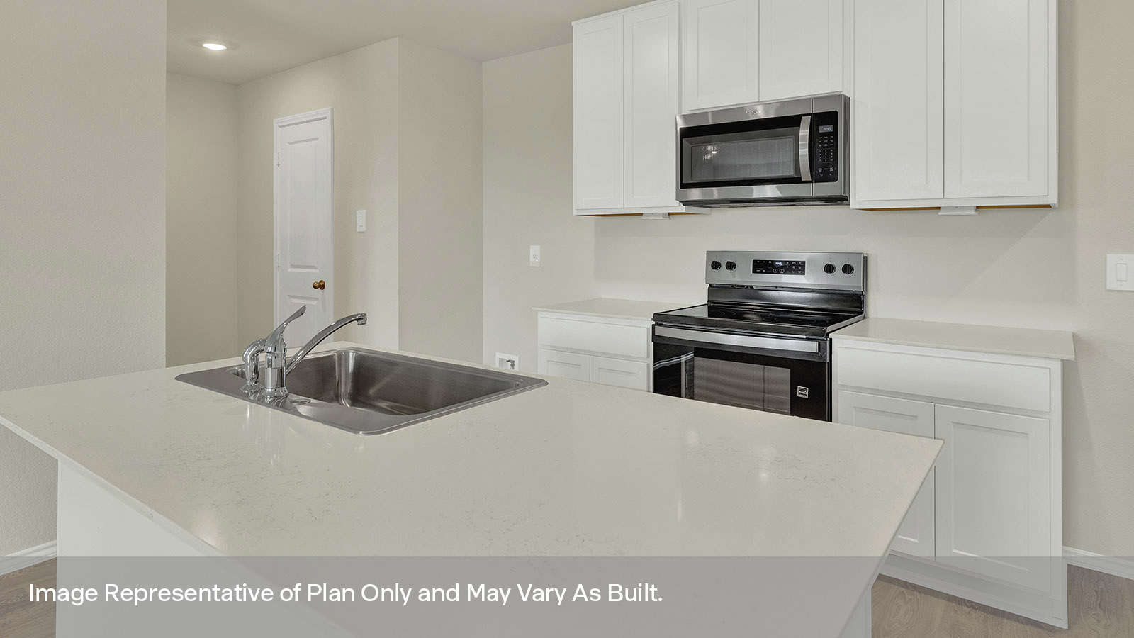 Kitchen with quartz countertops and stainless steel appliances.