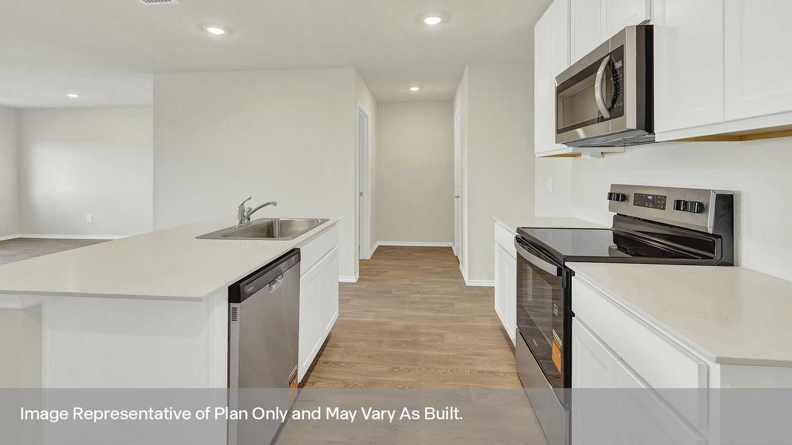Kitchen with quartz countertops and stainless steel appliances.
