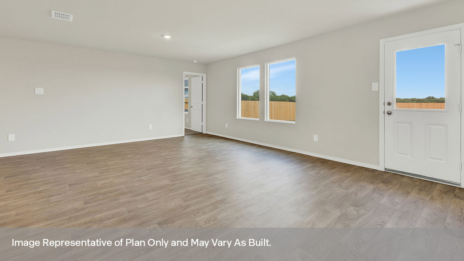 Dining room with vinyl flooring and a half lite exterior door.