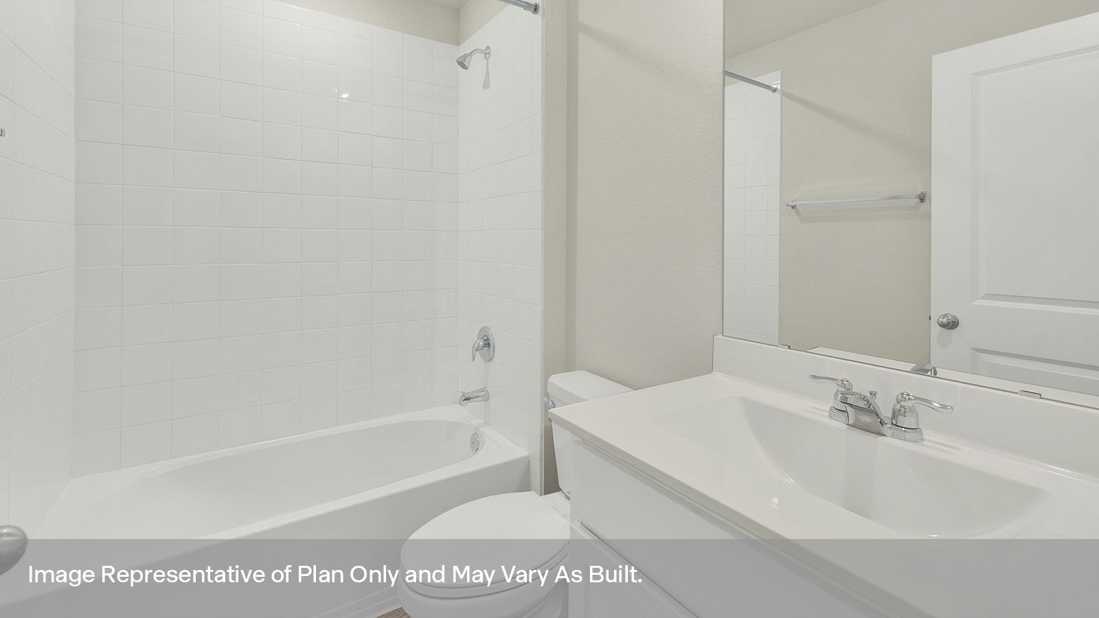 Hall bathroom with vanity, toilet, and tub with tile surround.